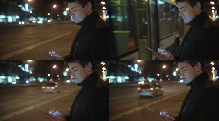 男人夜晚路边用手机