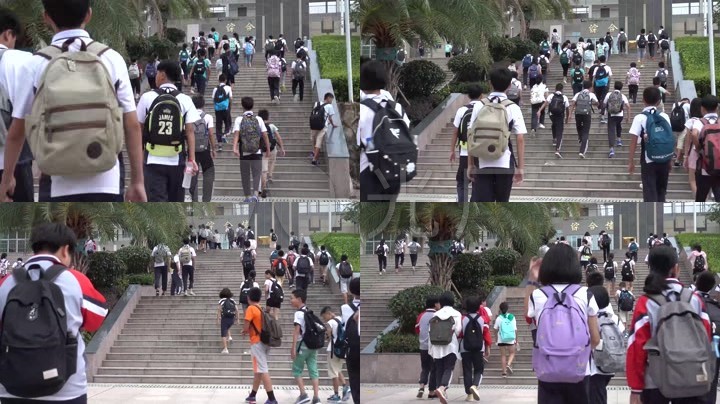中学生背着书包上学去踏入校门自行车摆放整