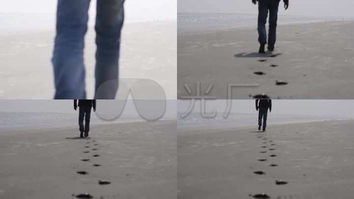 在沙滩上行走的人背后留下脚印