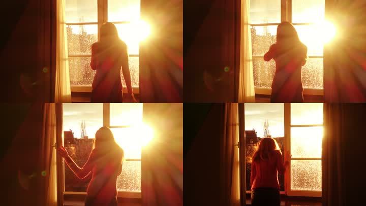 女孩打开窗户迎接清晨第一缕阳光