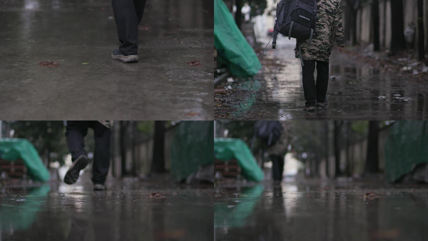 男人背包在雨中走路背影