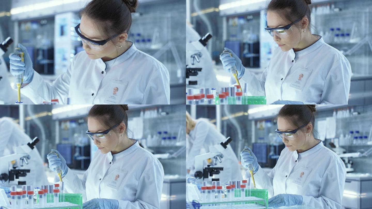 一位女科学家在一个现代化的大实验室里用微量移液管填充试管.