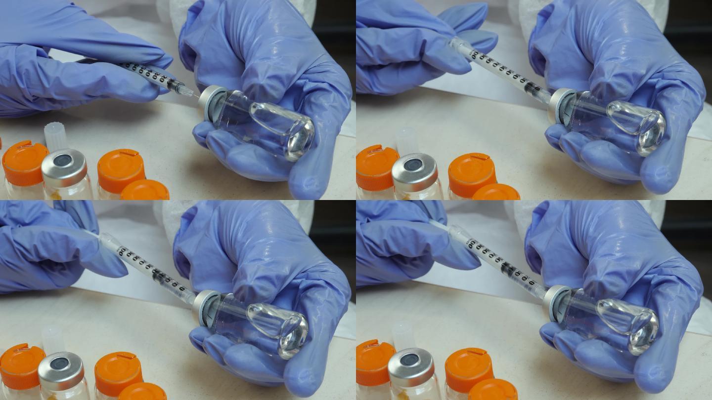 护士从药瓶里把药液注入注射器