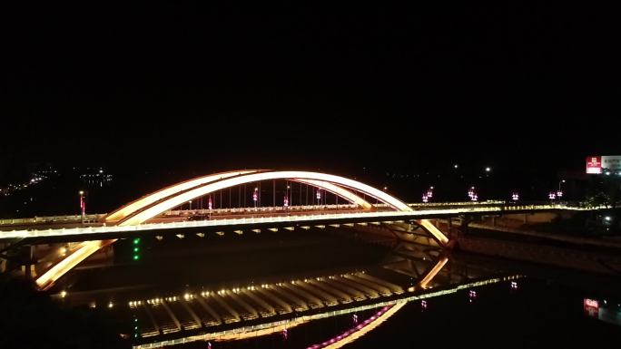 城市夜景拱桥湖面倒映航拍贺州
