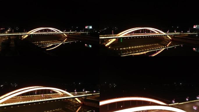 城市夜景拱桥湖面倒映航拍贺州