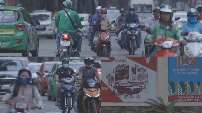 越南街头骑摩托的人城市人文