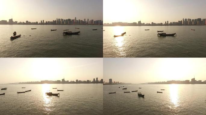 航拍杭州江边的落日渔船
