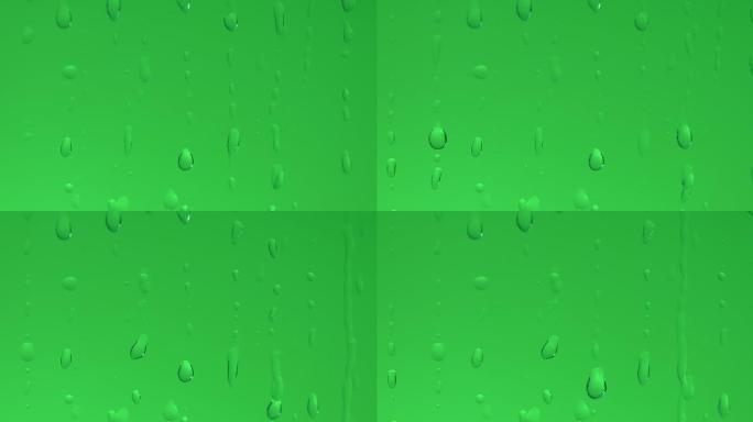 绿色背景前的水滴滑落