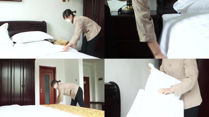 酒店客房打扫人员整理床铺