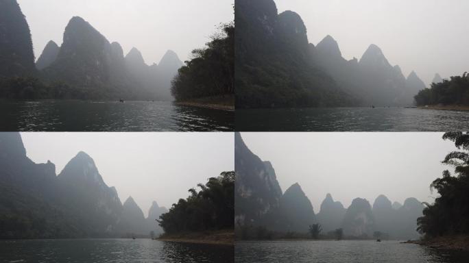 行驶中的竹筏船只阴雨绵绵河流青山绿水