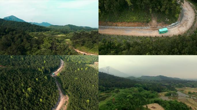 航拍山水山路森林客车行驶山田地五星红旗