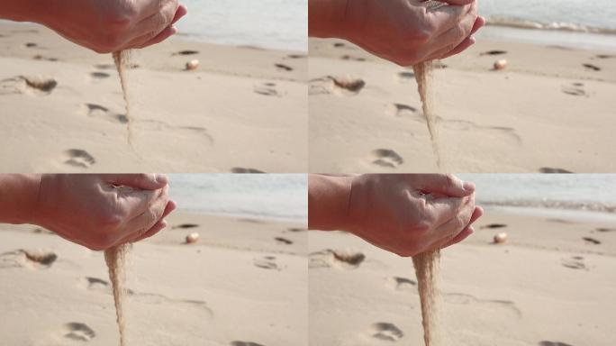 双手手捧沙子手握沙子海边