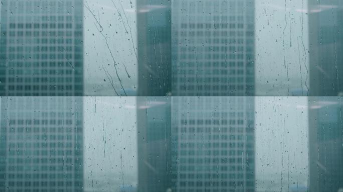 玻璃窗外下雨雨滴水珠低落空镜