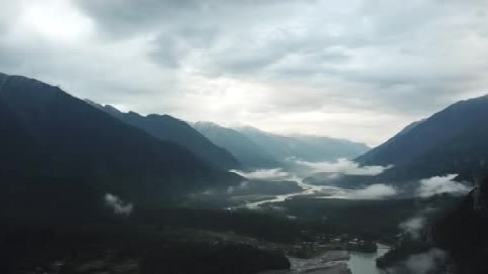 航拍西藏波密县川藏线的雪山河谷江水云雾丛