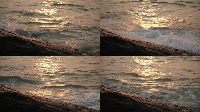 海边浪花逆光汹涌拍打海岸