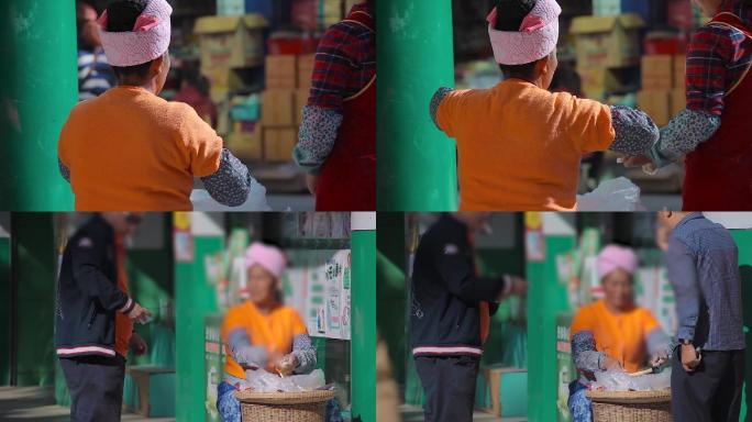 少数民族妇女在街边售卖自制酥糖-