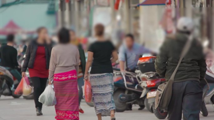 中缅边境街上走着的傣族妇女特色服饰-