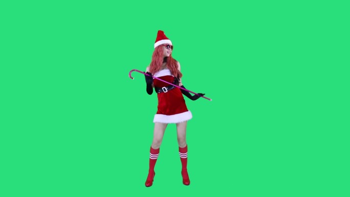 红发圣诞节美女在跳拐杖舞
