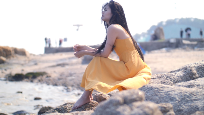 长裙女孩坐海边吹风思考，唯美文艺视频素材