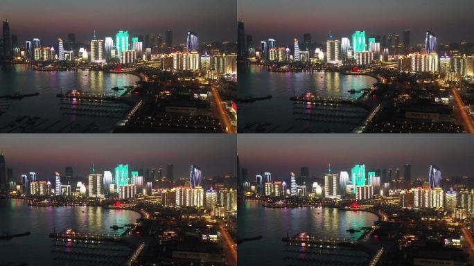 4K黄昏航拍青岛城市天际线灯光秀