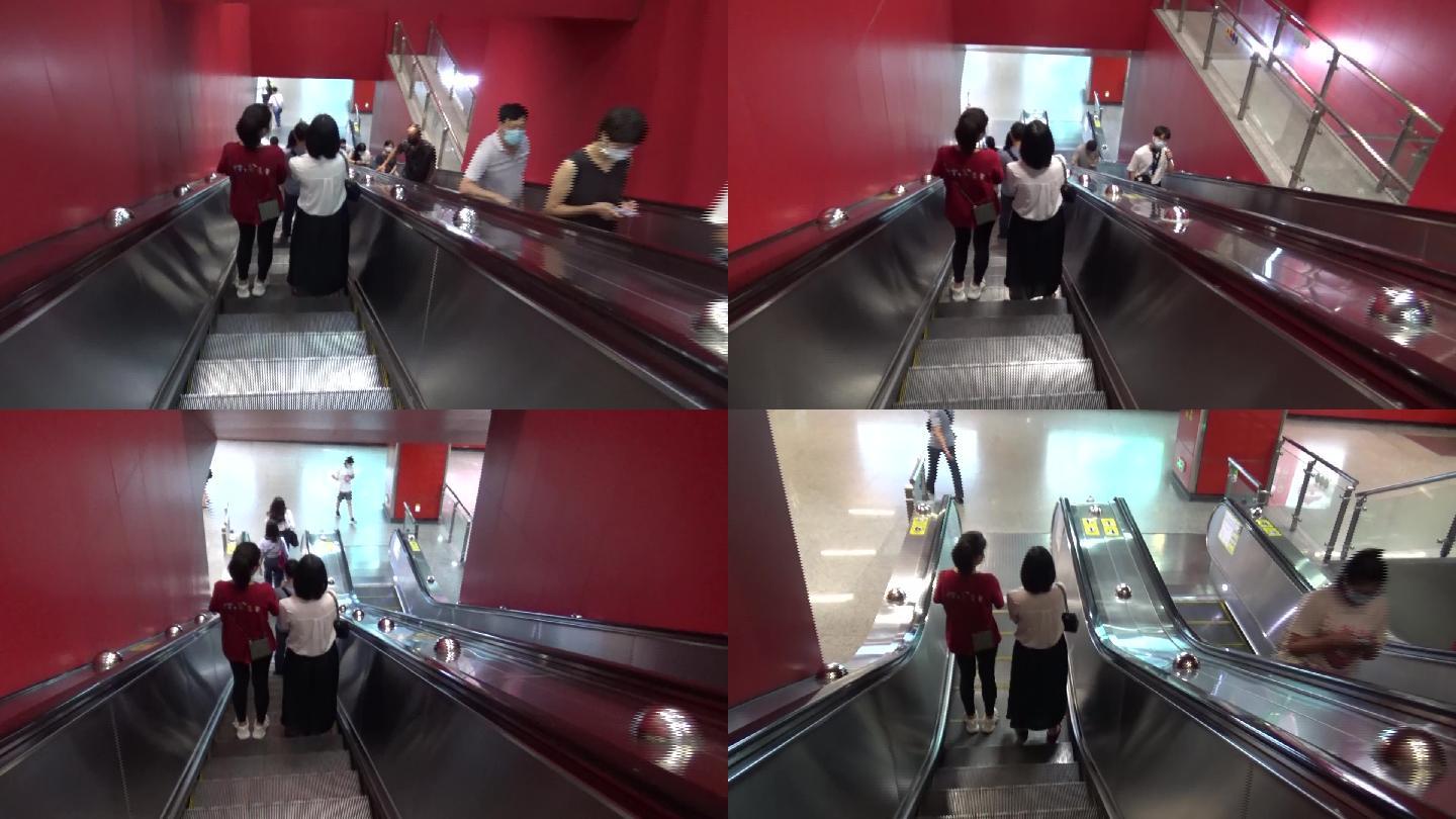 夏天广州地铁周末休闲的市民搭乘手扶梯进站