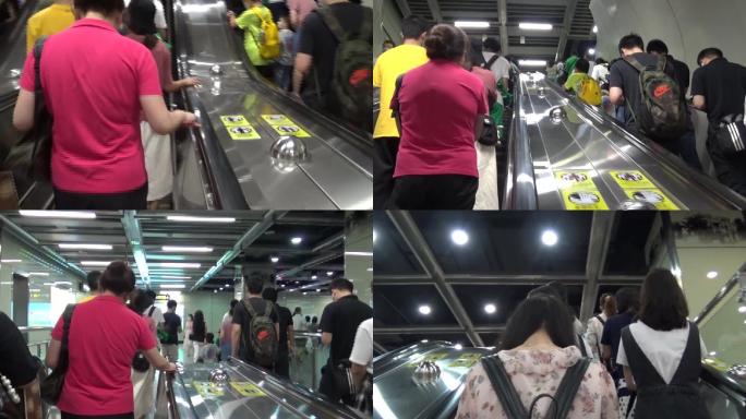 夏天广州地铁周末休闲的市民搭乘手扶梯出站