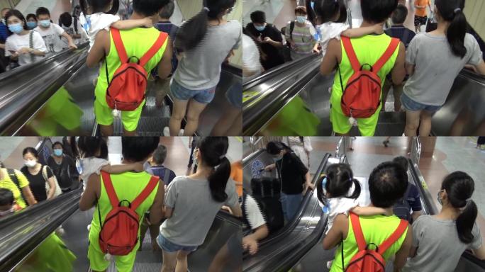 夏天广州周末休闲的市民一家三口搭乘地铁