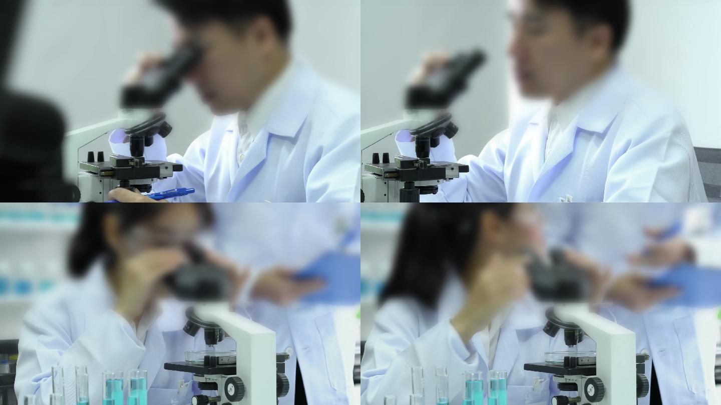 医疗中心科学家在科学实验室看显微镜