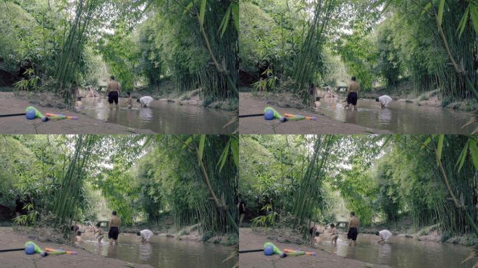 休闲避暑的人们在小溪里面摸螃蟹螺蛳小虾