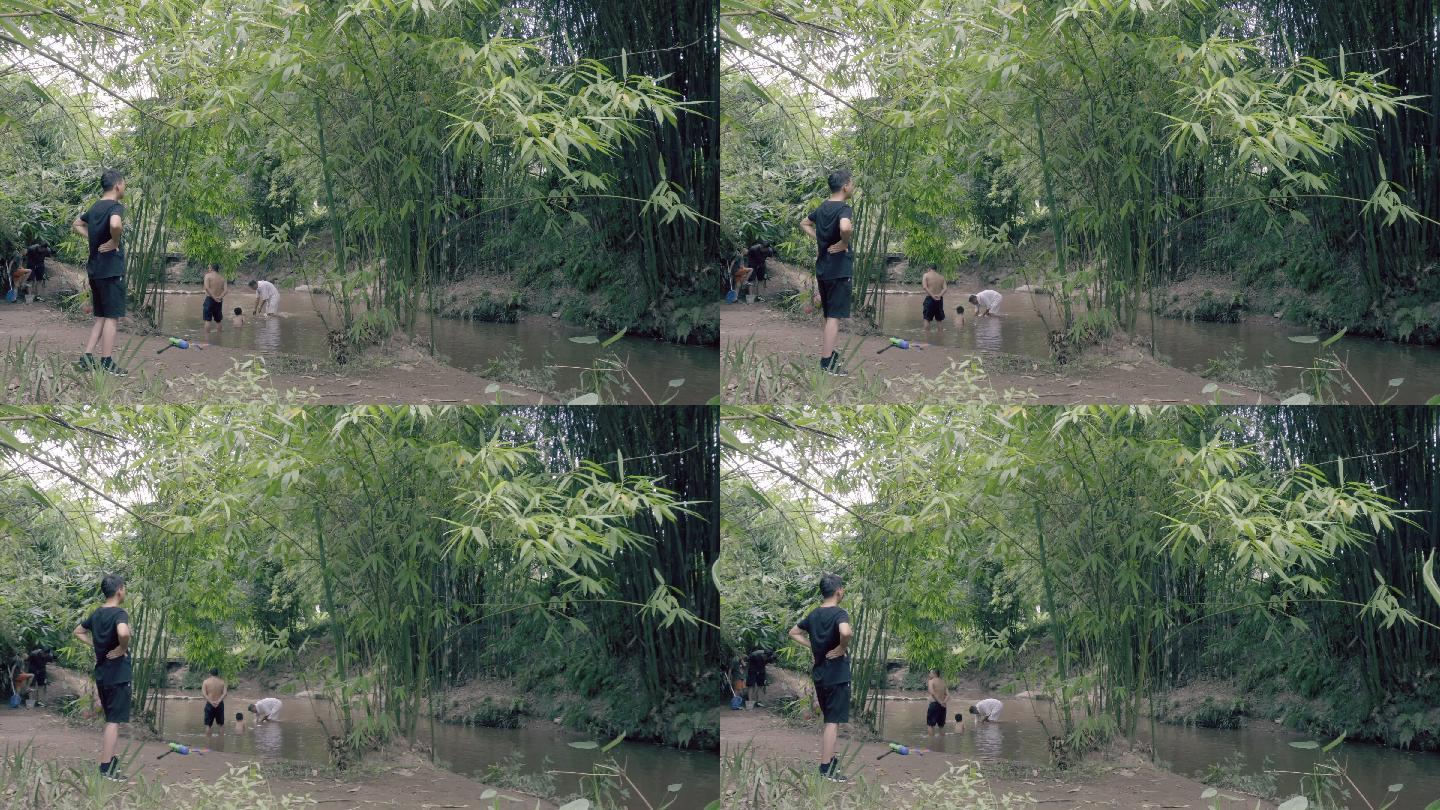 在森林里的竹林小溪沟里人们在戏水冲凉