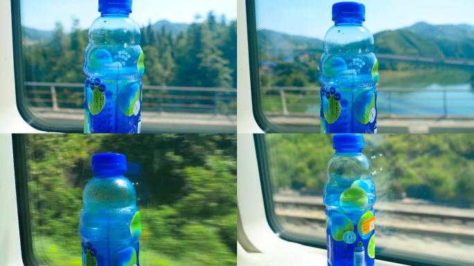高铁车窗户上的饮料水瓶，车窗外风景4k