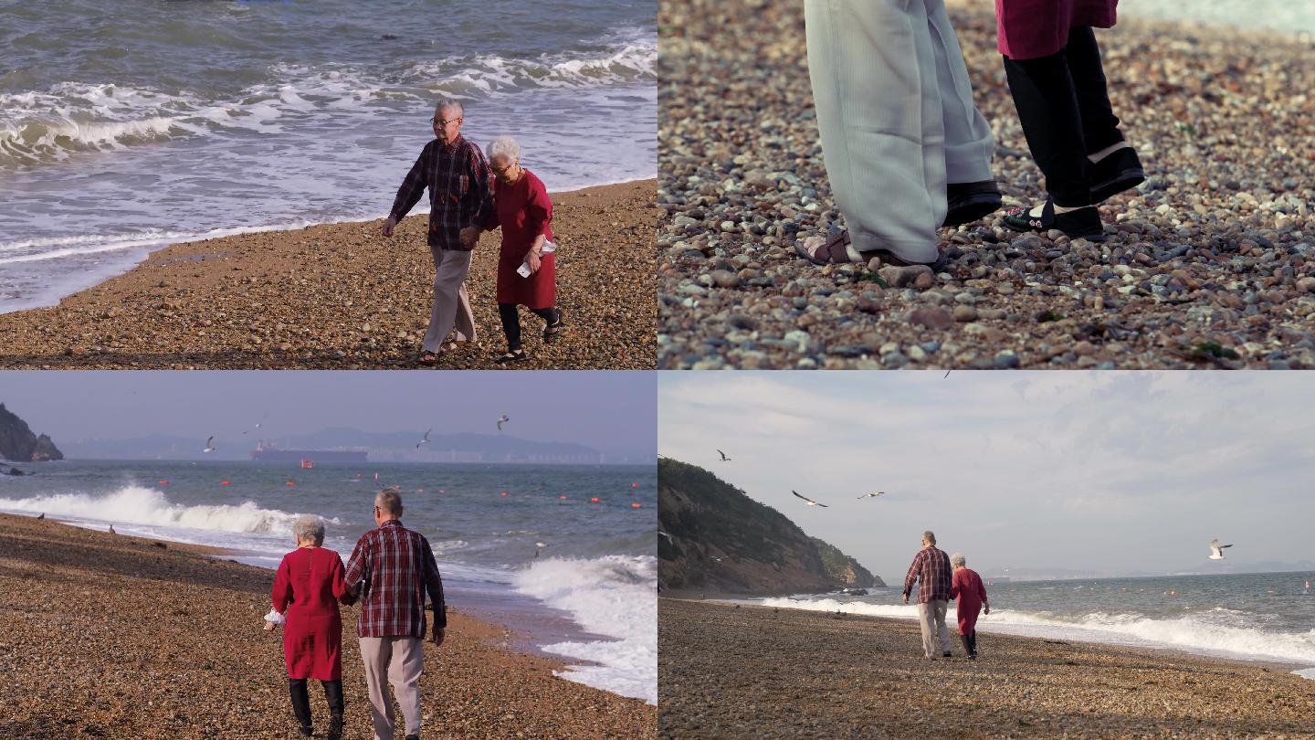 老人海边手拉手散步