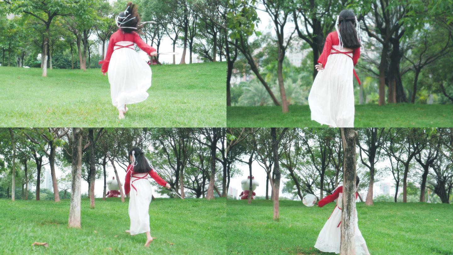 公园里小女孩穿着古装汉服草地奔跑背影4k