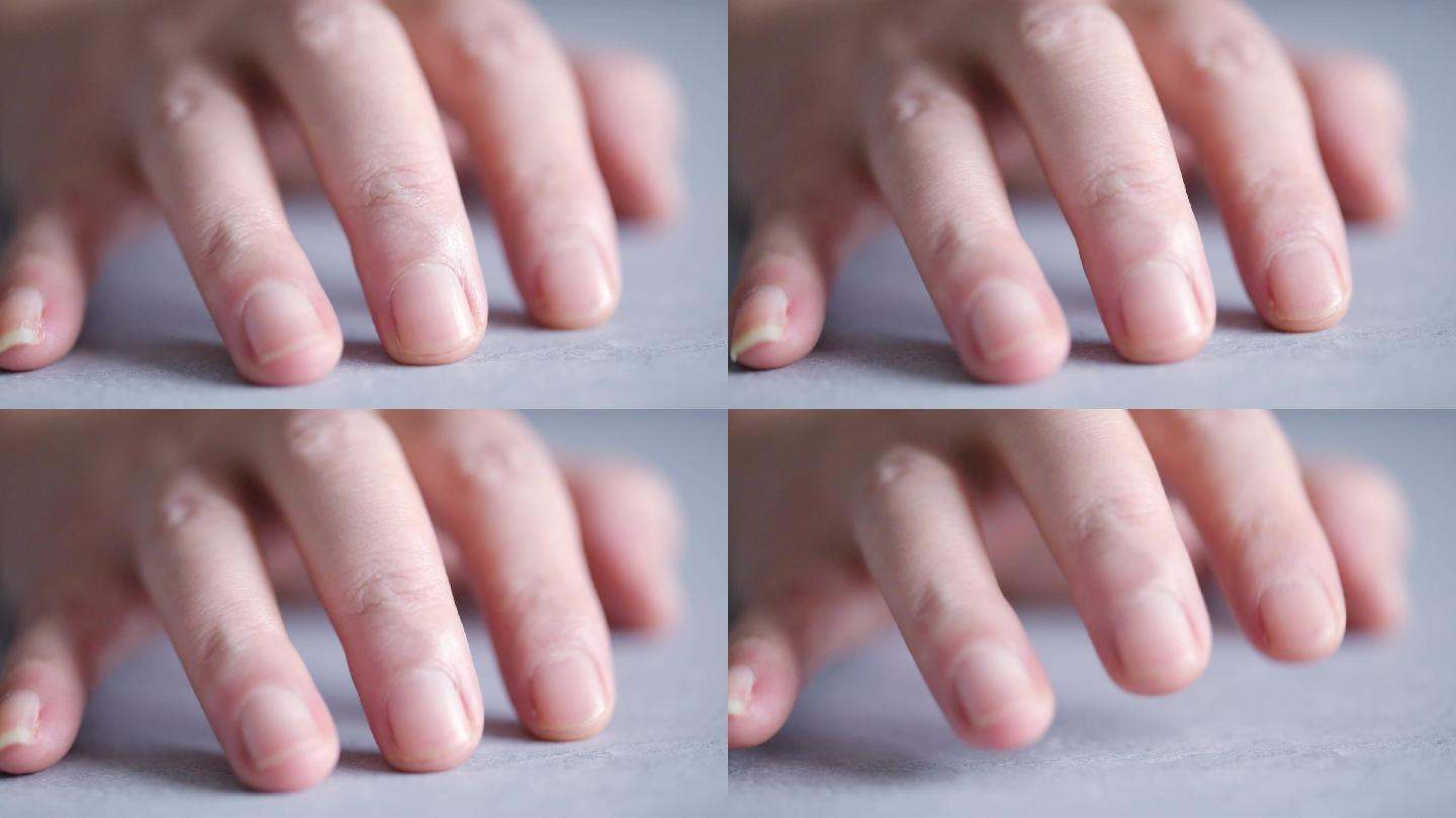 敲击桌面的手指特写