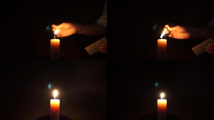 火柴点燃蜡烛-黑暗中的烛光