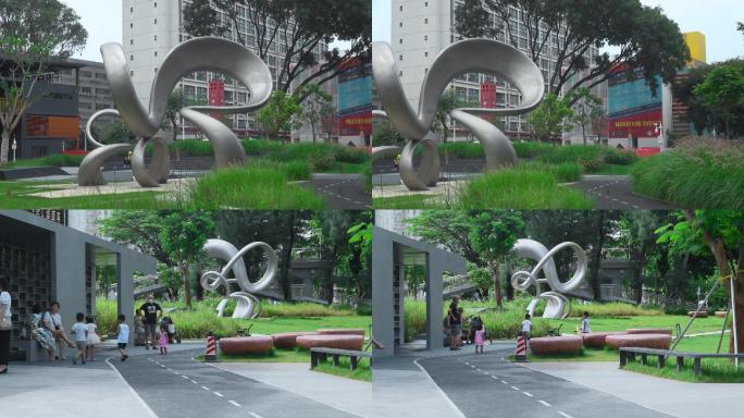 深圳建设小公园不锈钢雕塑和游人