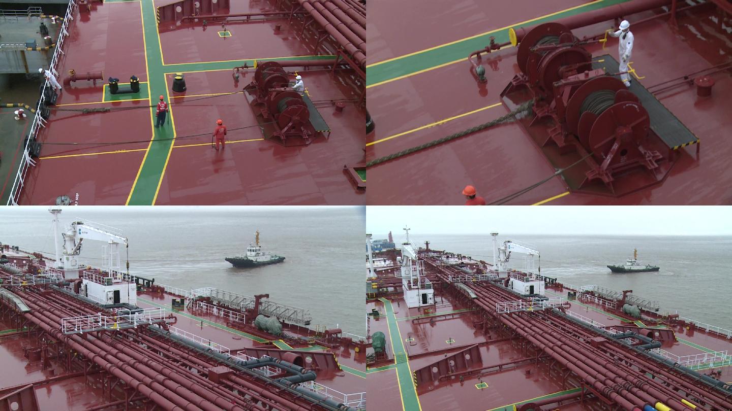 拖船拖万吨油轮驶离开码头，甲板海员作业