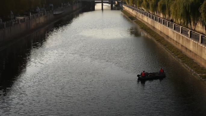 北京庆丰公园通惠河河道清理工人乘船在水面