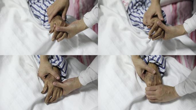 护士握着老人病人的手抚慰关心患者