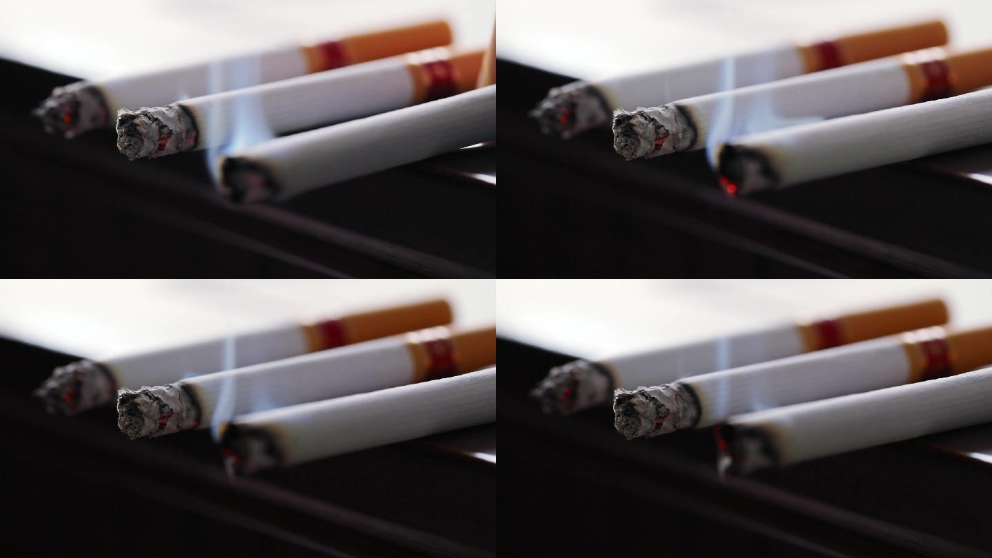 桌边摆放的三支点燃的香烟