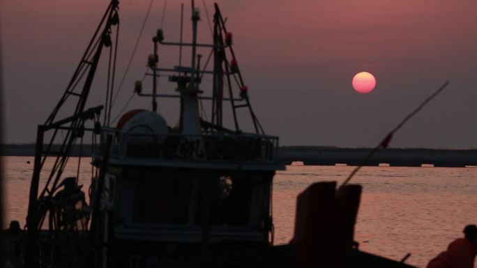 夕阳下入港的渔船