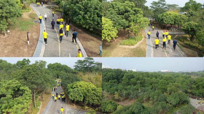 4k航拍深圳坪山聚龙山公园道路行人后面跟