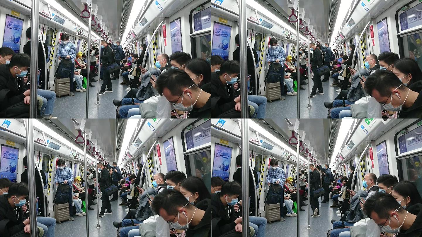 地铁车厢内景观，不少乘客在看手机