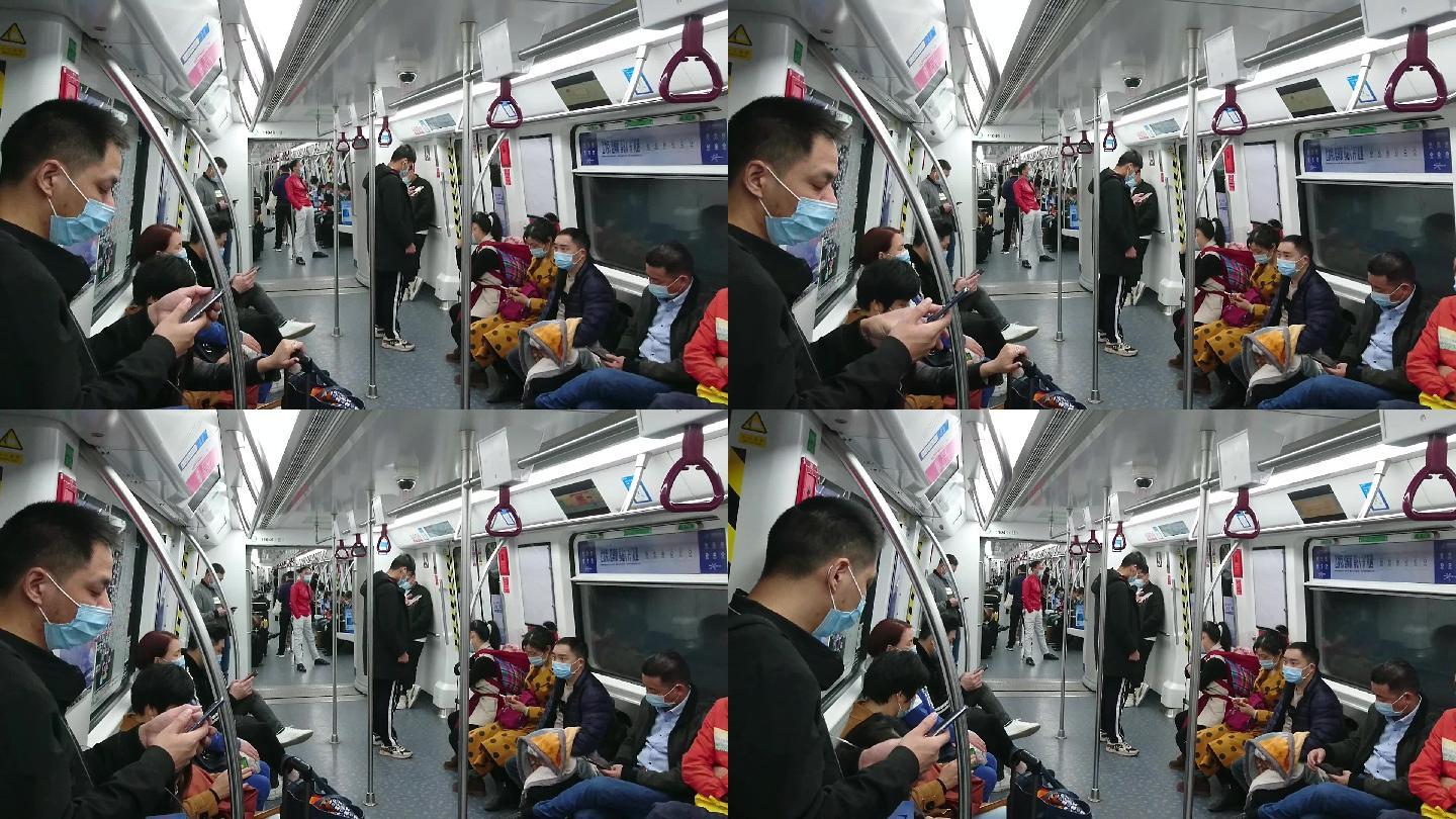 地铁车厢内景观，不少乘客在看手机