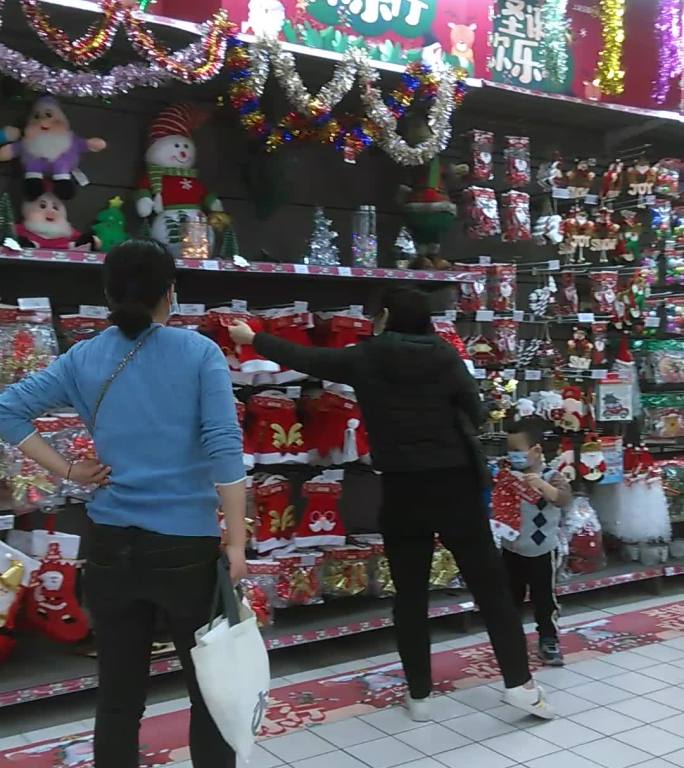 平安夜家长们带着孩子在商场购买圣诞节饰品