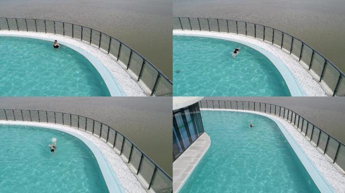 海景天际泳池自由泳美女泳衣俯视航拍拉