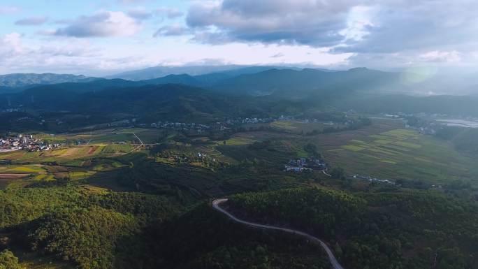 4k航拍云南山区日出光影稻田小路