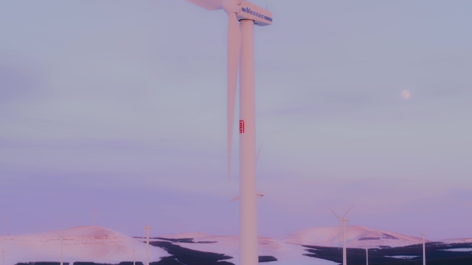 航拍雪地夕阳风力发电机塞罕坝