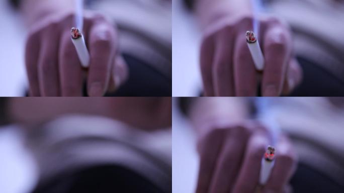 夹在指间的香烟吸烟手部动作特写