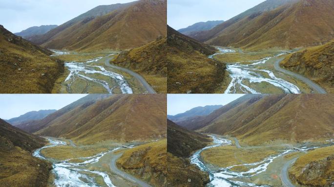 4K航拍深邃山谷蜿蜒山路冰河视频